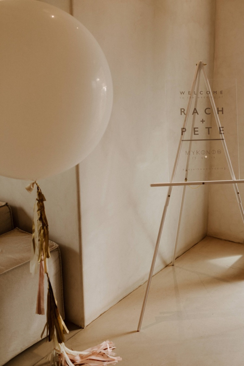 A white balloon and easel in a room, creating a serene ambiance for a dream wedding in Mykonos.