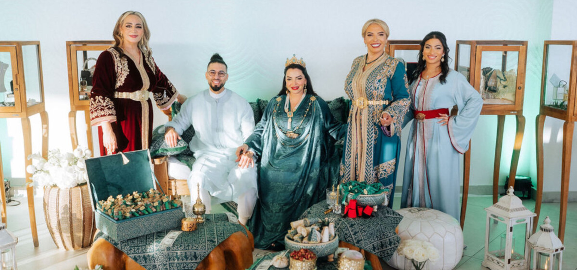 Luxury Mykonos wedding henna party with the bride, groom, and guests in traditional attire surrounded by elegant cultural décor and lounge styling.