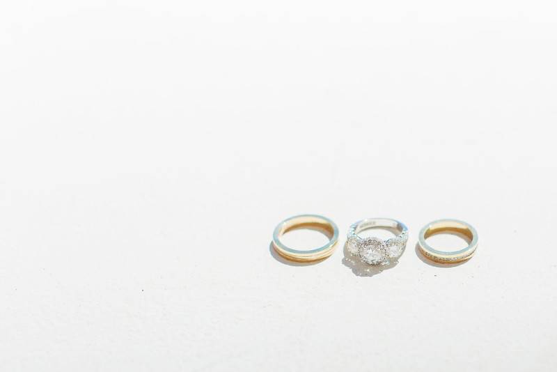 Three elegant wedding rings arranged on a pristine white surface, symbolizing love and commitment. Perfect for Mykonos weddings.