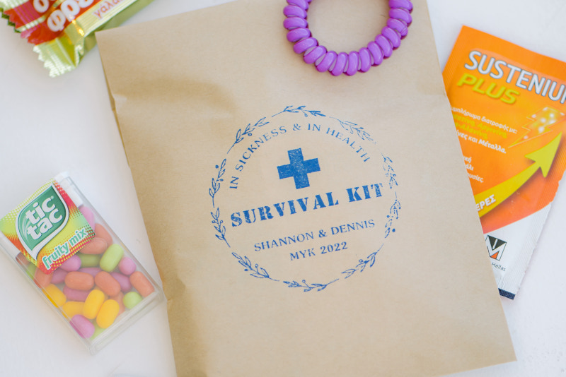 A survival kit bag featuring various items created as a gift for a unique luxury wedding details, designed for a Mykonos wedding.